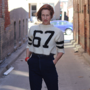 Andrea Donaldson standing in back alley.