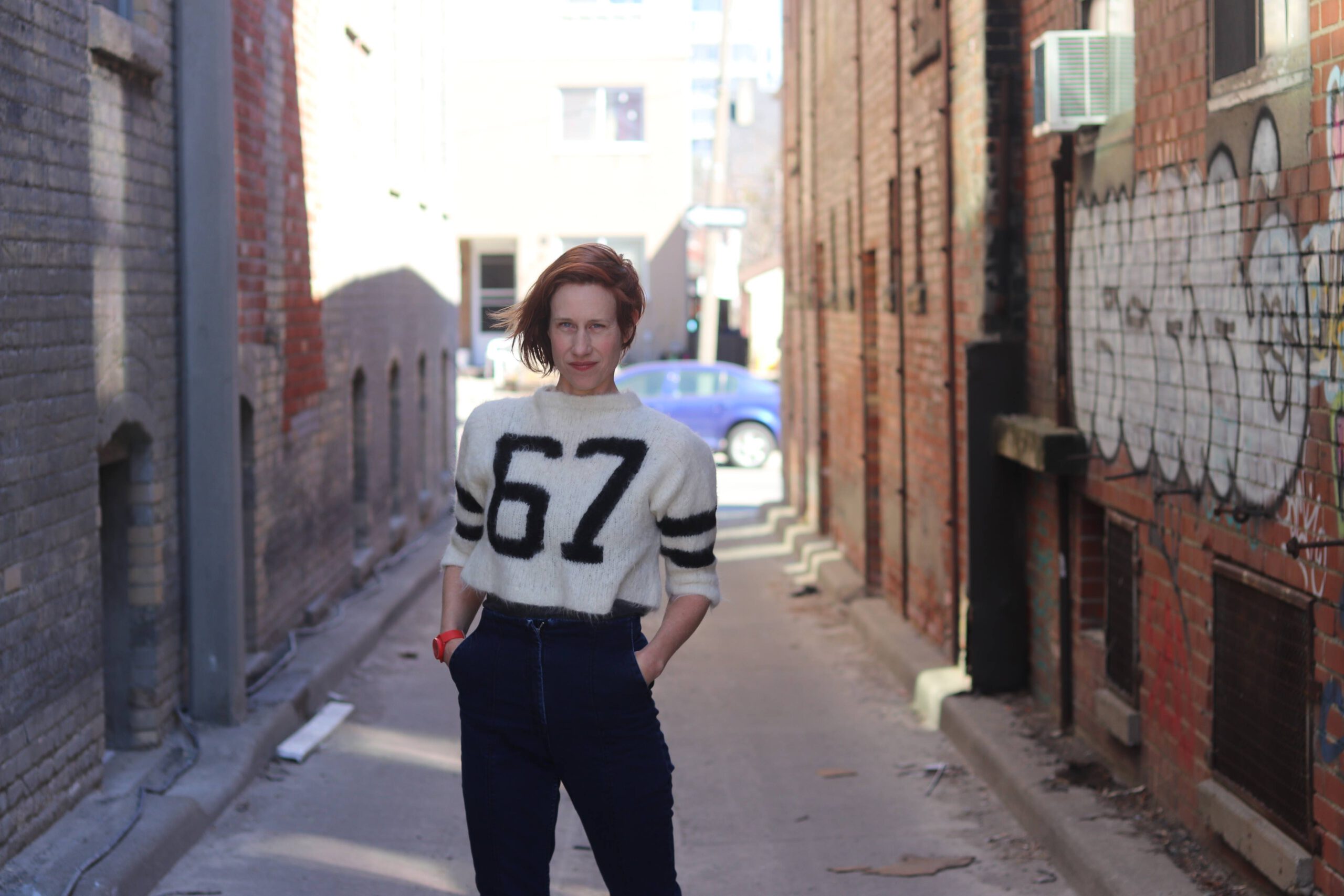 Andrea Donaldson standing in back alley.
