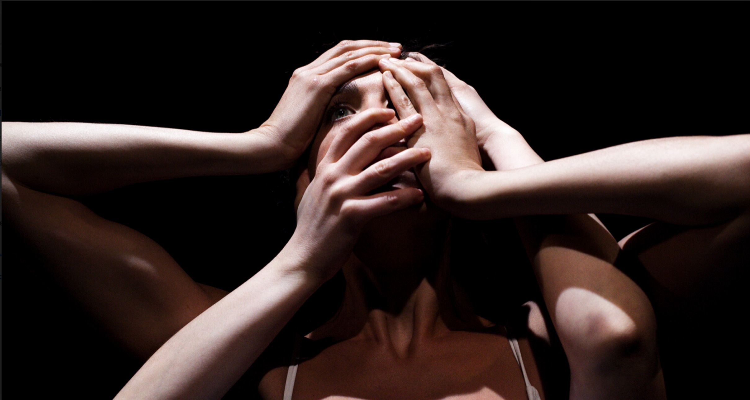 Woman with four hands covering her face.