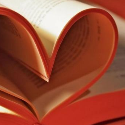 A book with pages curled to make a heart shape.