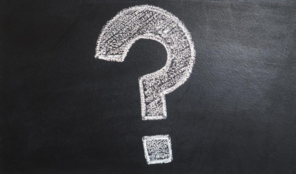 Question mark drawn in chalk on a blackboard.