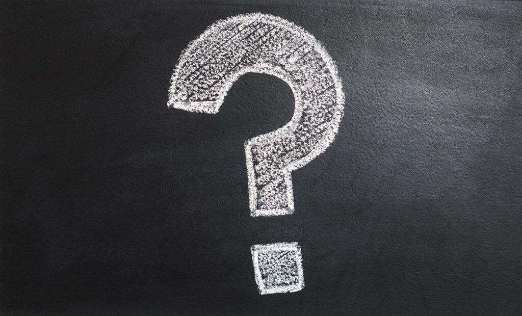 Question mark drawn in chalk on a blackboard.