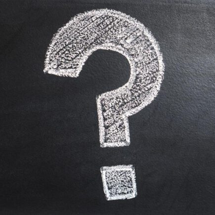 Question mark drawn in chalk on a blackboard.
