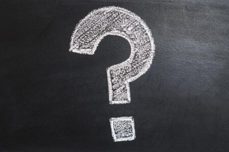 Question mark drawn in chalk on a blackboard.