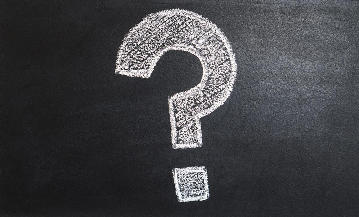 Question mark drawn in chalk on a blackboard.