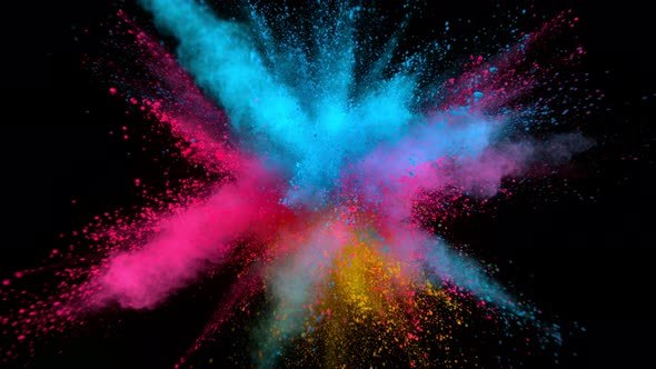 Colourful pigment explodes outwards on a black background.