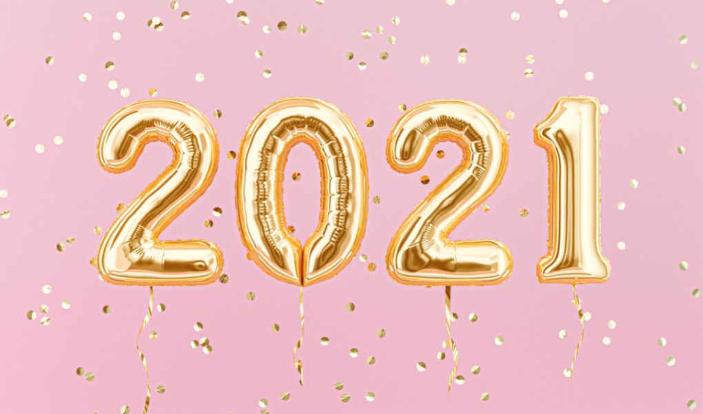 Gold 2021 balloons against a pink backdrop with the gold confetti falling.